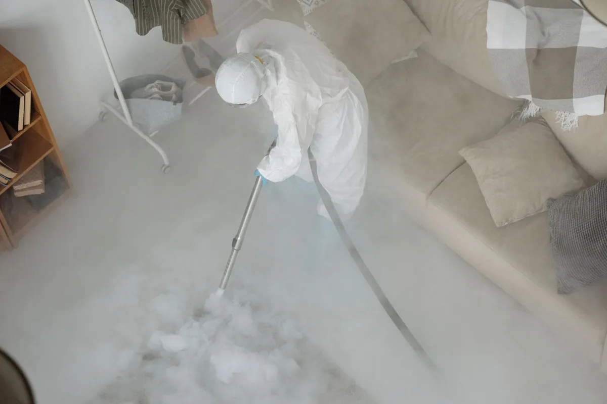 Biohazard cleanup technician in protective equipment, Midland, WA